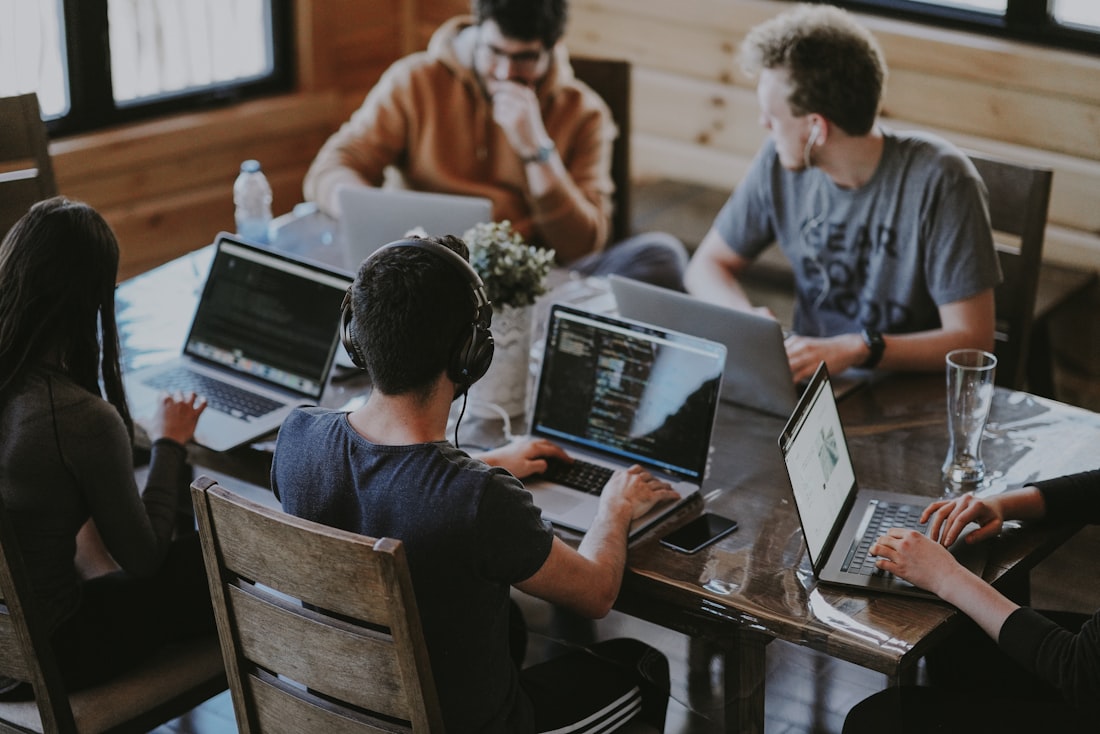 A team working together on laptops around a table